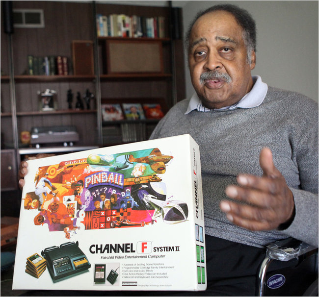 Gerald holding one of the first game systems The Fairchild Channel F System using a cartridge base system